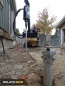 Installation of a Helical Screw Pile metal post foundation